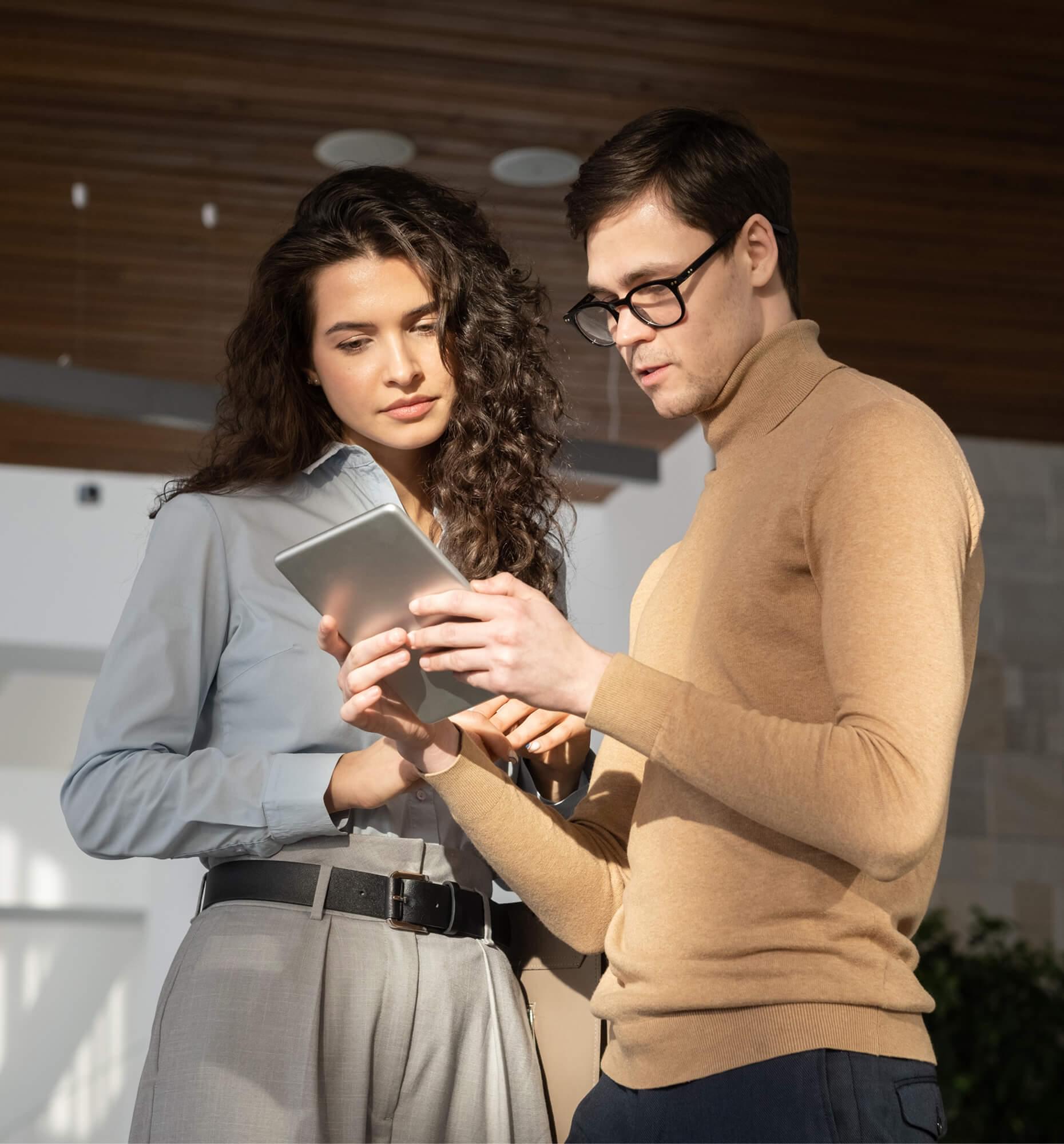 Man and woman, looking at the screen